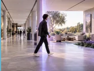 A visitor walking through a bright modern interior